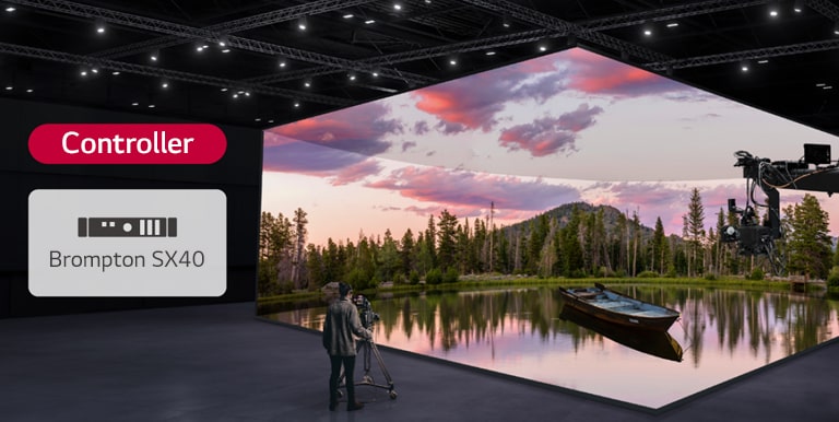 A virtual production studio which has curved LED walls and ceiling and floor LEDs is being filmed, and a compatible controller is being displayed next to it.