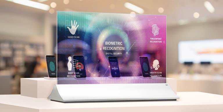 In a mobile store, a smartphone's functions are described on the transparent OLED screen in front of the smartphone.