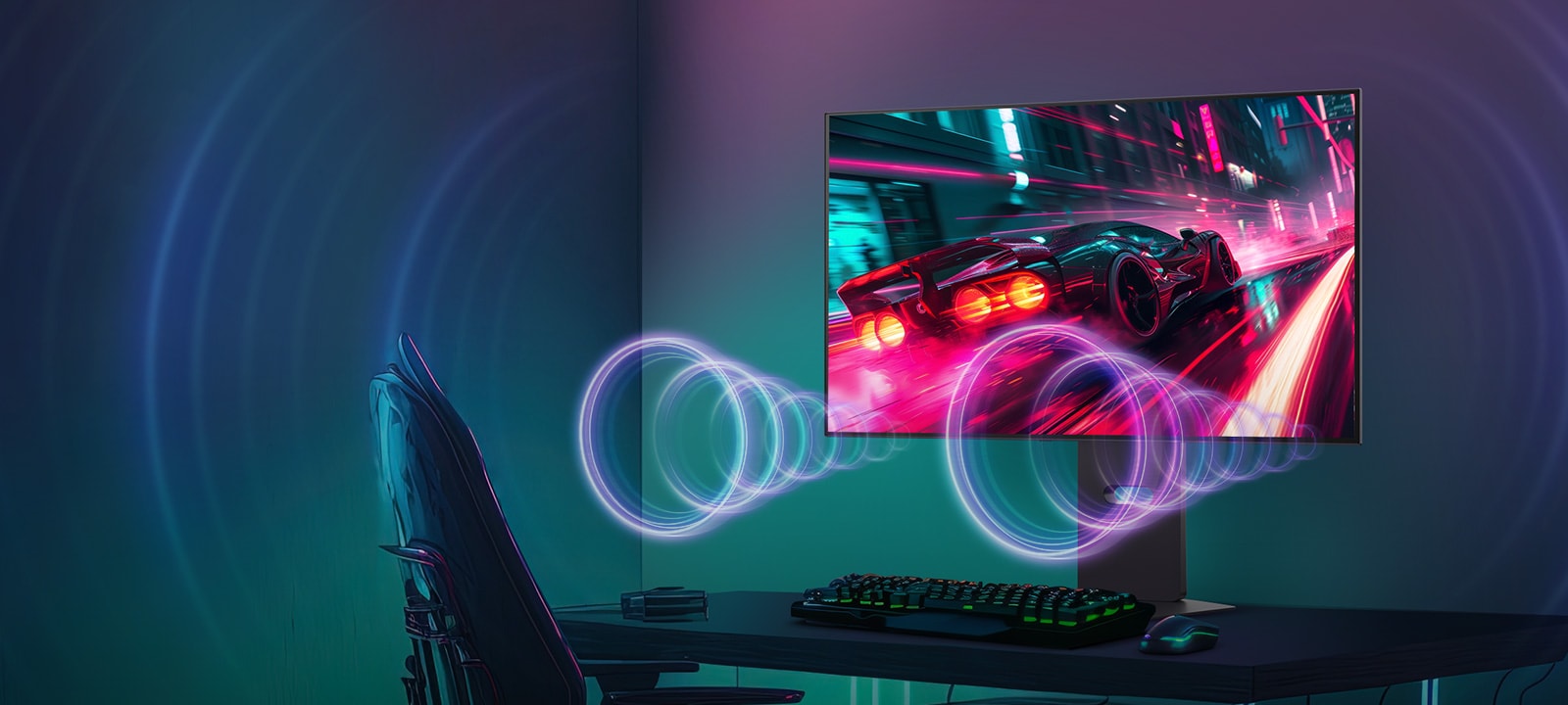 The monitor screen shows a racing game, while sound is coming from the speakers at the bottom of the monitor.