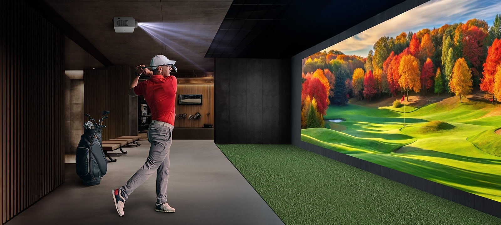 There is an indoor golf simulator with a golfer swinging and a vibrant autumn landscape projected on the wall.	
