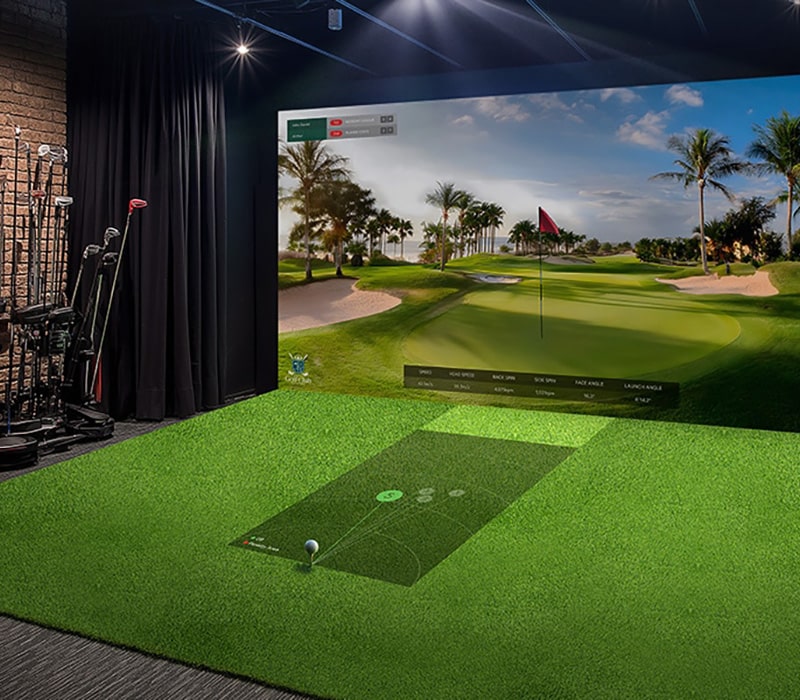 A golf simulator with moderate brightness; the projected screen appears dim and less vibrant, reducing visual clarity.	