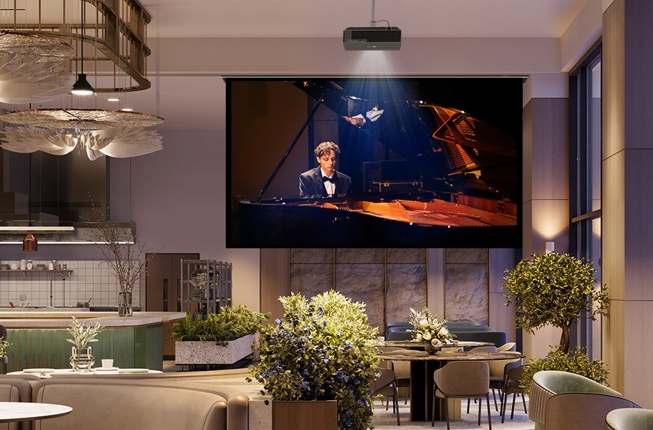 A projector is mounted on the restaurant ceiling, displaying a video of a man playing the piano.	
