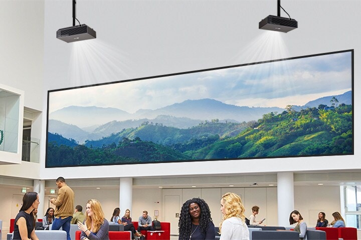 A projector in the lobby is displaying a mountain image on the wall.	