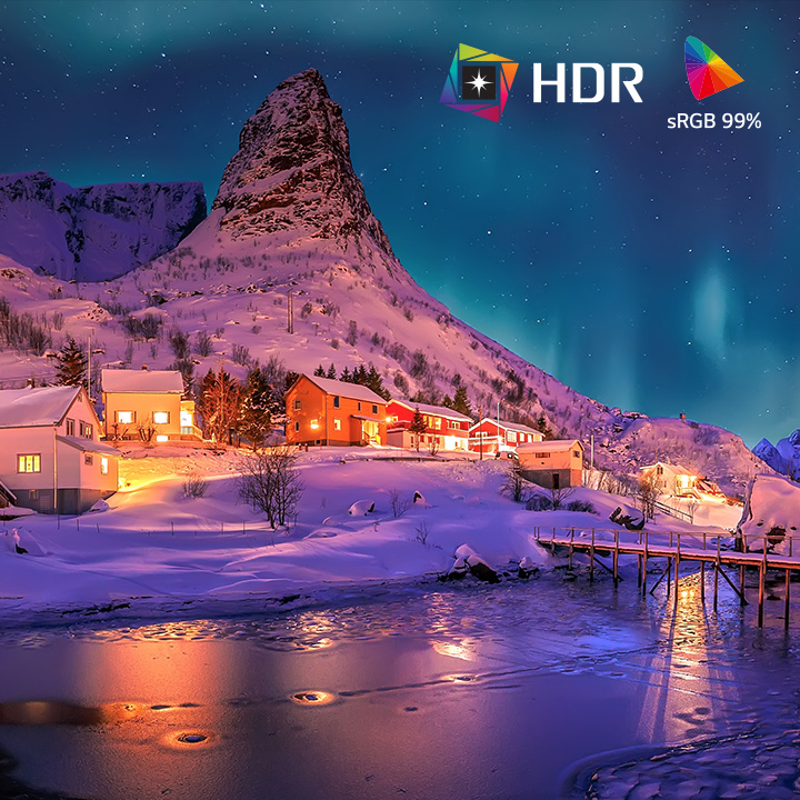 Split-screen comparison showing SDR versus HDR10 Pro with sRGB 99% color gamut, highlighting brighter highlights, deeper shadows, and more vivid color detail in a snowy village night landscape.