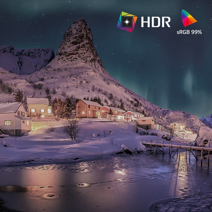 Split-screen comparison showing SDR versus HDR10 Pro with sRGB 99% color gamut, highlighting brighter highlights, deeper shadows, and more vivid color detail in a snowy village night landscape.