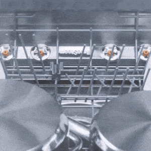 Dishwasher interior with TrueSteam removing spots and cleaning dishes.