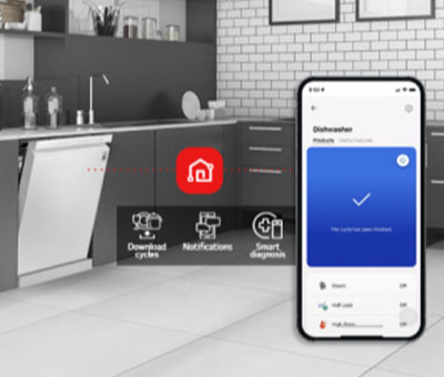 Kitchen interior with partially open free-standing dishwasher and LG ThinQ® app showing cycle complete notification.