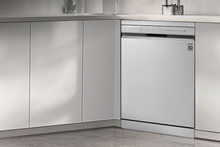 Overall view of a modern kitchen featuring an LG freestanding dishwasher seamlessly installed under the counter.