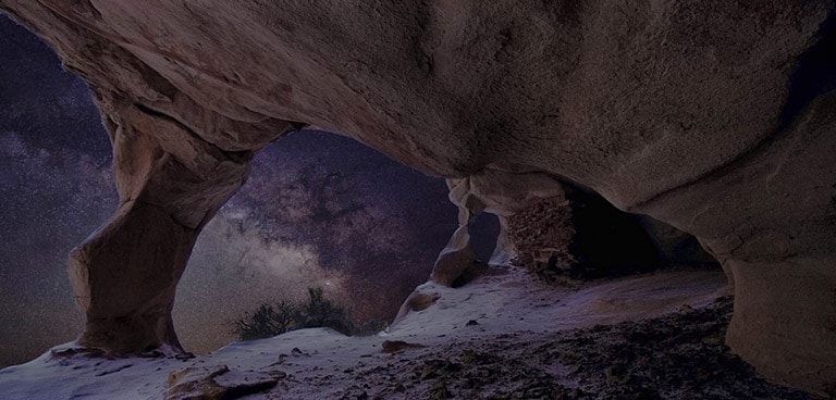 Dull evening nature landscape, view of the night sky from under a rock formation. Graphics appear to show the visual enhancement process of OLED Dynamic Tone Mapping Pro. The resulting landscape has much better contrast, with stars now visible against the night sky, darker blacks, and brighter whites overall. 