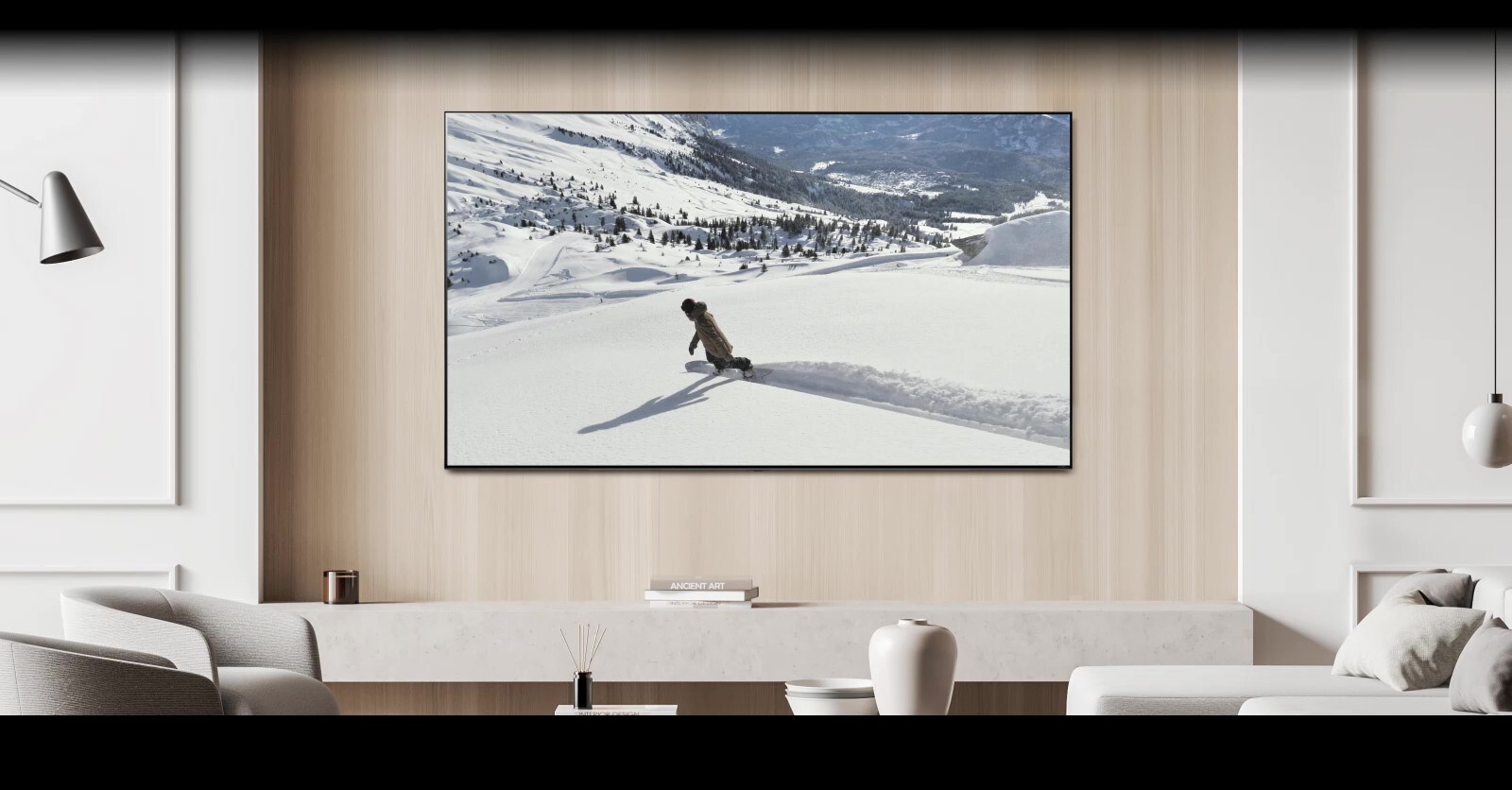 In the living room, there is a TV on the wall displaying a video of a person skiing. A message bubble saying "Send screen to bedroom TV" appears at the bottom of the screen, causing the TV to turn off and the video to continue playing on the bedroom TV. Another message bubble saying "Send screen to living room TV" appears, causing the video to switch back to the living room TV and the bedroom TV to turn off.