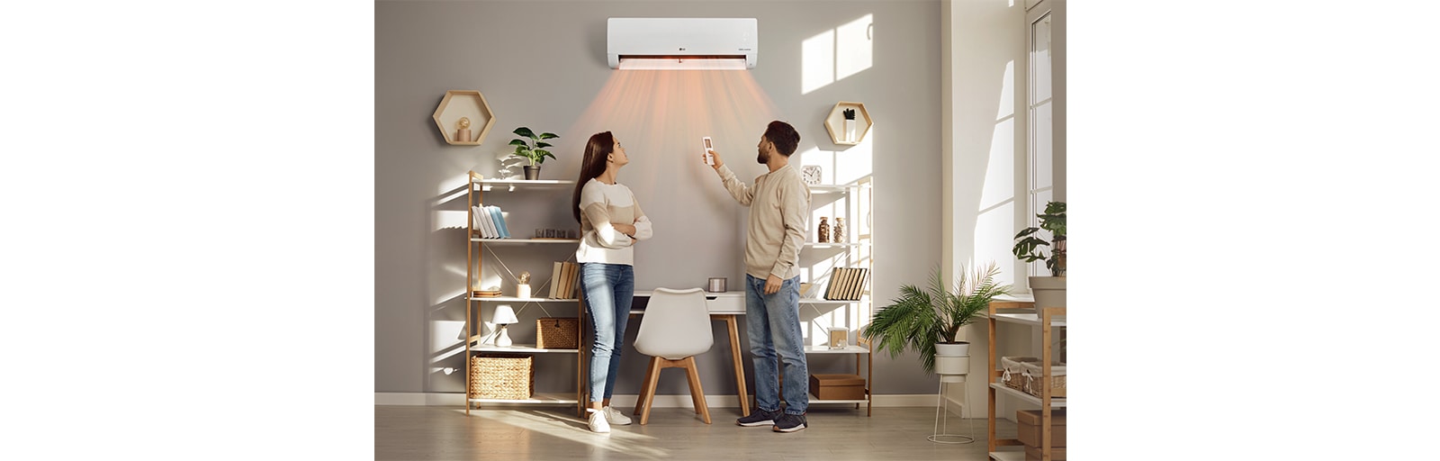 A man and a woman are blown by a warm wind in front of a heater