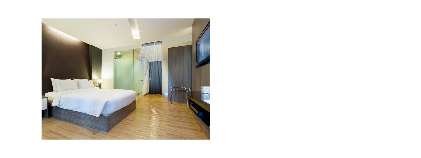 A ceiling concealed duct supplying blue-colored air current in a hotel room with brown toned walls and a queen bed covered with white beddings.