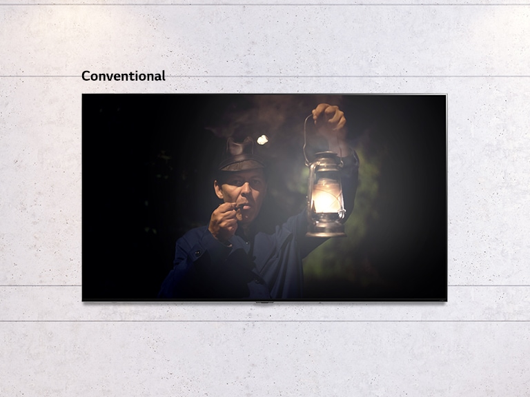 Scrollable image of a wall mounted TV showing a dark scene of man holding a lamp. The scene alternates between a regular size TV and a large screen LG QNED MiniLED TV.