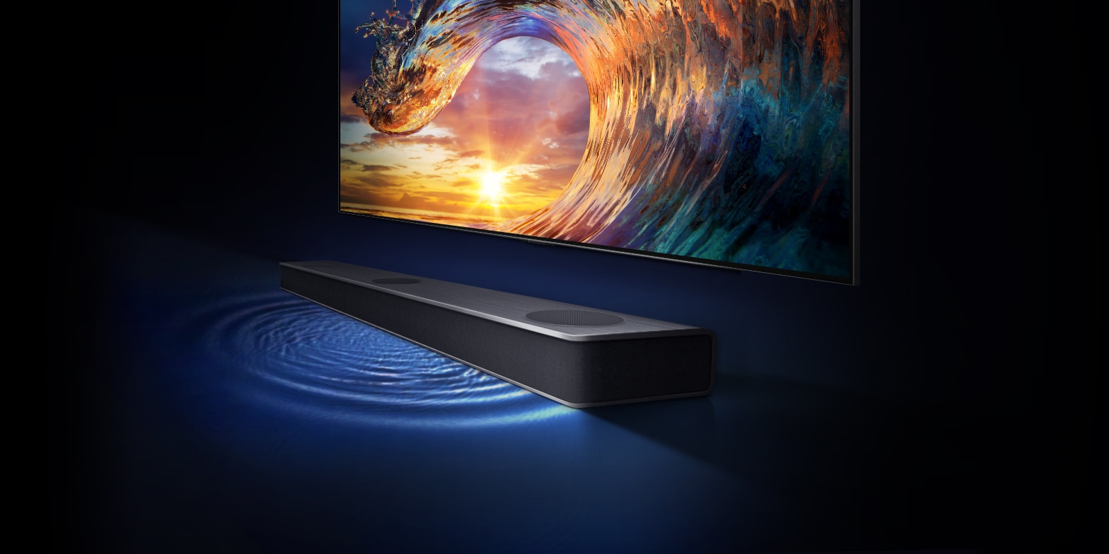 TV shows the sunset sky and rainbow-colored waves. There is a sound bar under the TV and the sound wavelength is on the floor.
