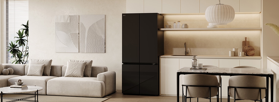 A cozy living room and kitchen are reflected in the sleek design of the lg multi door refrigerator with mirror doors.