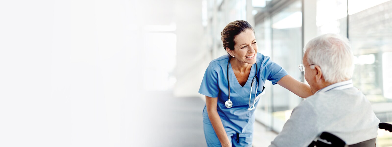 An image of a nurse smiling to a patient.