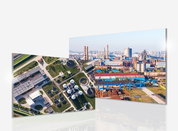 Aerial view showcases a sewage plant with a green area to the left, and slightly overlapping, an industrial site to the right.