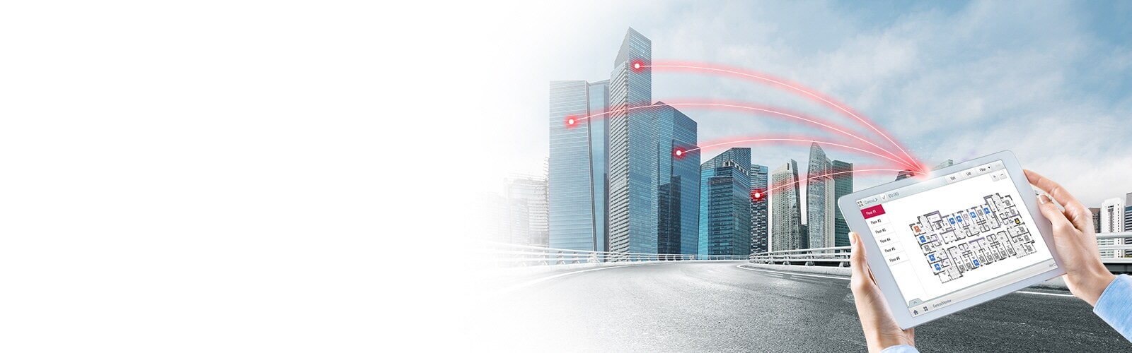 A person holds a tablet displaying a control solution, with red lines connecting to several buildings.