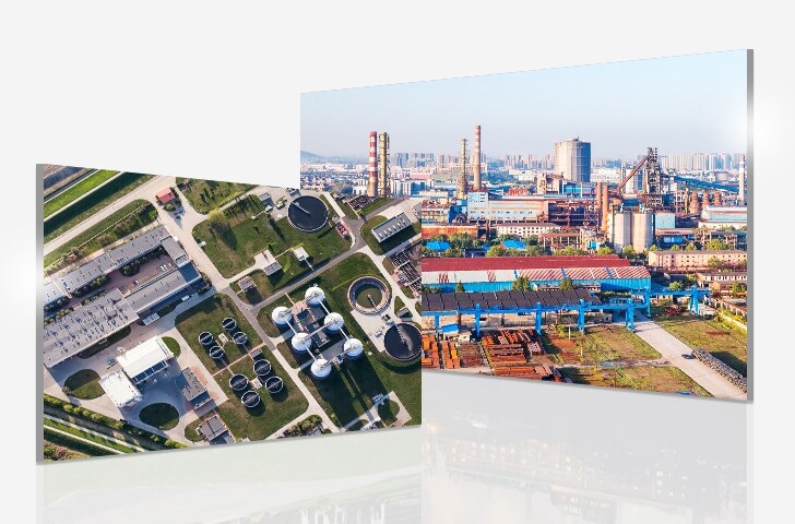 Aerial view showcases a sewage plant with a green area to the left, and slightly overlapping, an industrial site to the right.