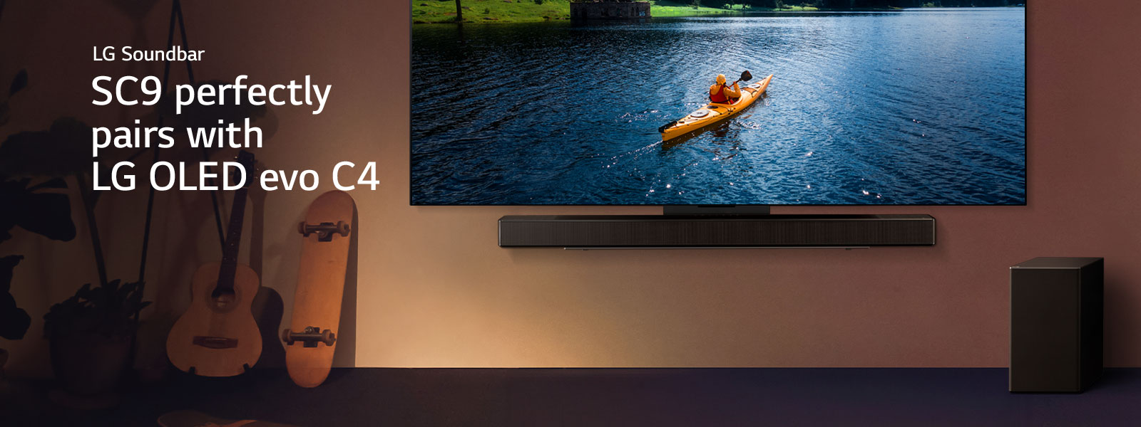 LG TV and Soundbar mounted on a wall and a suboofer on the floor to the right. On the TV, a person in a kayak on a lake is displayed, and soft shadows cascade over the wall.