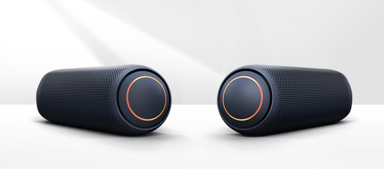 On a white background, two XBOOM Go's point to each other. They both have red lighting. 