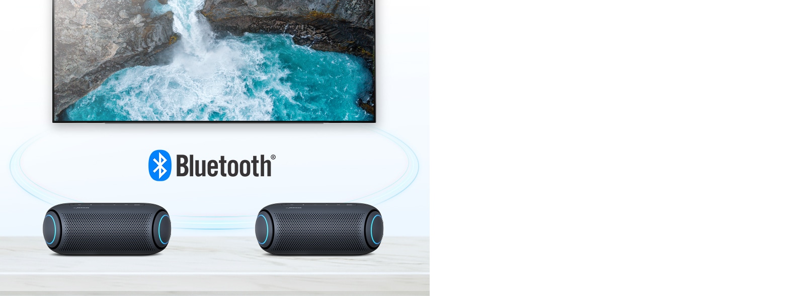 On a table, two LG XBOOM Go with sky blue lighting are in front of a TV showing a waterfall.