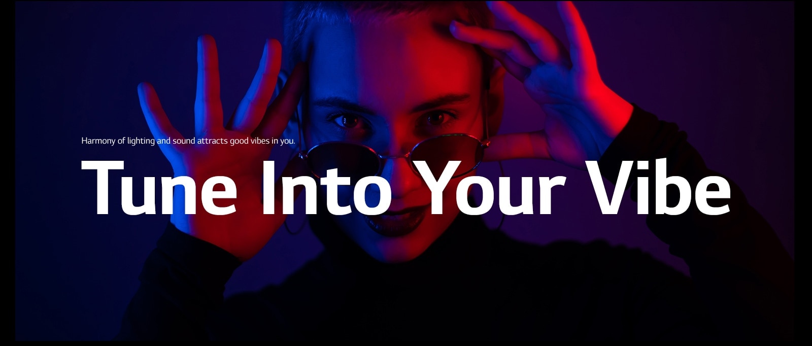 Woman strikes a pose in vivid lighting.