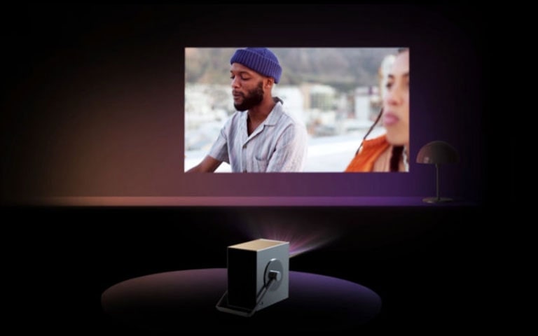 Video of function - A scene where the projector automatically adjusts when a woman places it on the floor.	