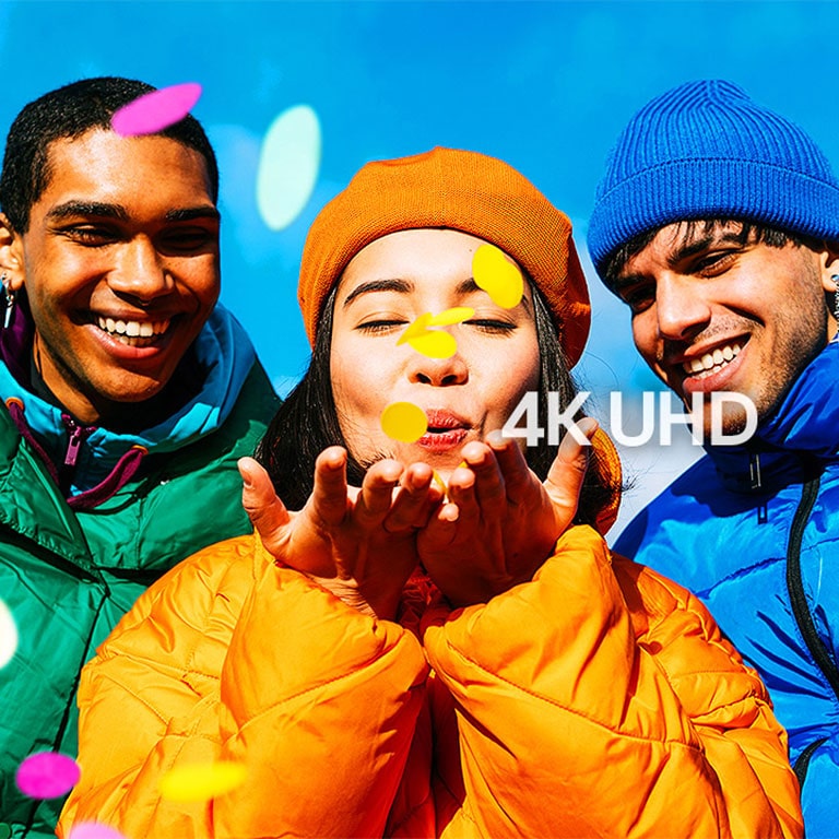 Three people wearing green, yellow, and blue outfits.