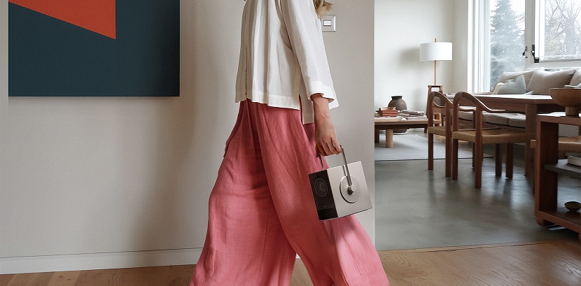 Image of a person carrying the LG CineBeam Q with a handle.