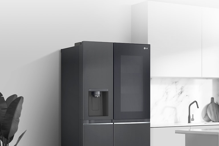 A side view of a kitchen with a black InstaView refrigerator installed.