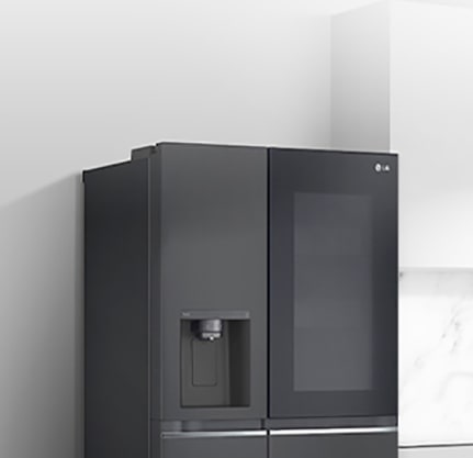 A side view of a kitchen with a black InstaView refrigerator installed.