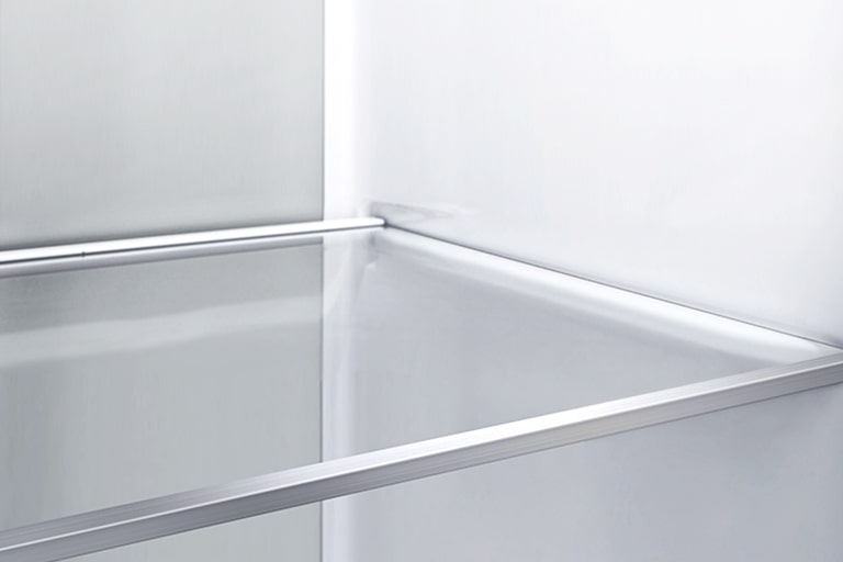 A diagonal view of the shelf with metallic paneling on the interior of the refrigerator.