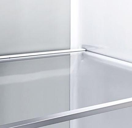 A diagonal view of the shelf with metallic paneling on the interior of the refrigerator.