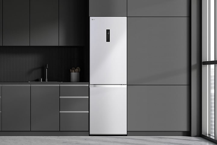 Modern kitchen with a refrigerator that blends seamlessly into surrounding cabinetry, resembling a built-in model.