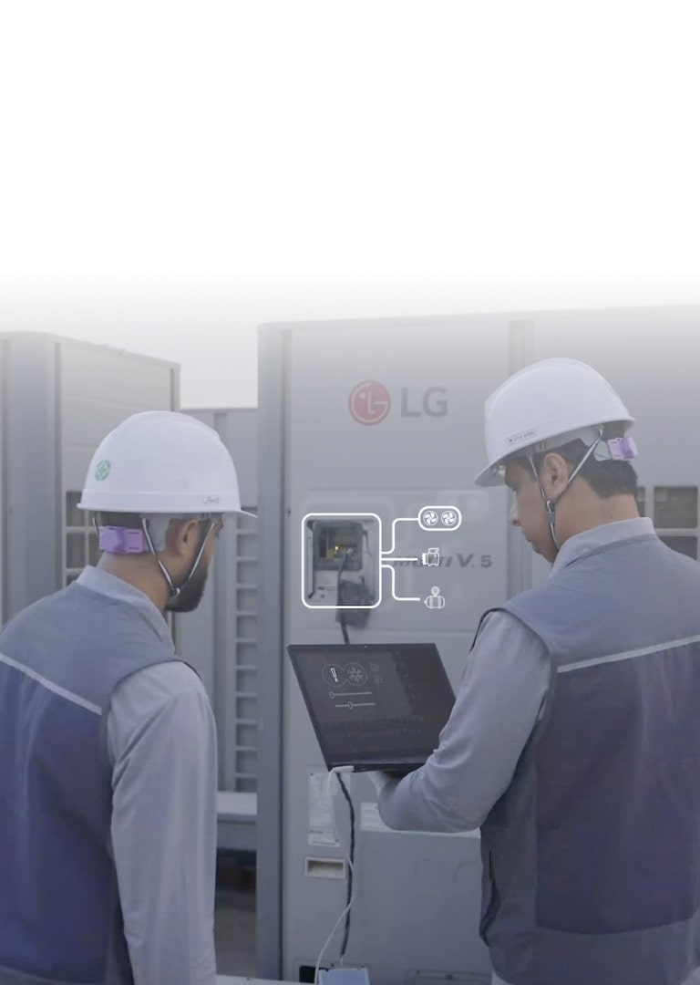 Technicians using a laptop to service LG MULTI V HVAC equipment, showing smart diagnostic interface during maintenance work.