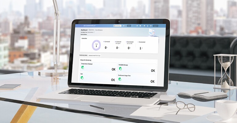 On the desk, a laptop displays the LG ConnectedCare (DMS License) dashboard on its screen.