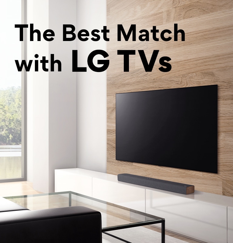 A soundbar is placed on a white TV cabinet and TV is placed on a wooden wall. There is a forest view outisde the window. Text is written on image - The Best Match with LG TVs. 