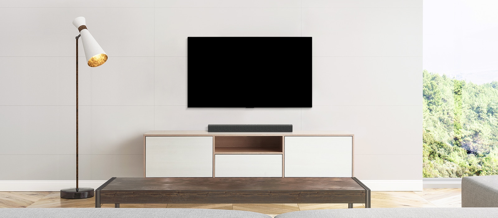 A TV and a soundbar placed in a plain living room.