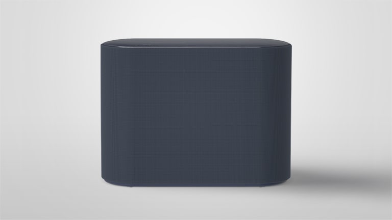 A subwoofer is placed on a white floor. The scene changes to zoom into two components inside the subwoofer that are slightly vibrating and sound wave effects coming out from the two components. The text says Opposite sonic vibrations from both ports minimize each other. The scene changes to zoom out once again and show the exterior of a subwoofer. 