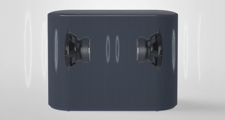 A subwoofer is placed on a white floor. Two components inside the subwoofer are shown.