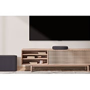 LG Soundbar QP5, A TV, soundbar, and subwoofer placed in a plain living room, QP5, thumbnail 3