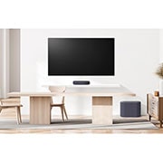 LG QP5 | 3.1.2ch | 320W | Dolby Atmos, A front view of a soundbar and subwoofer placed in a dining room, QP5, thumbnail 5