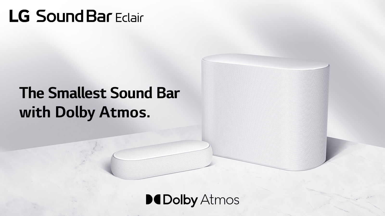 A soundbar and a subwoofer are placed on a marble floor, soundbar and subwoofer facing opposite sides