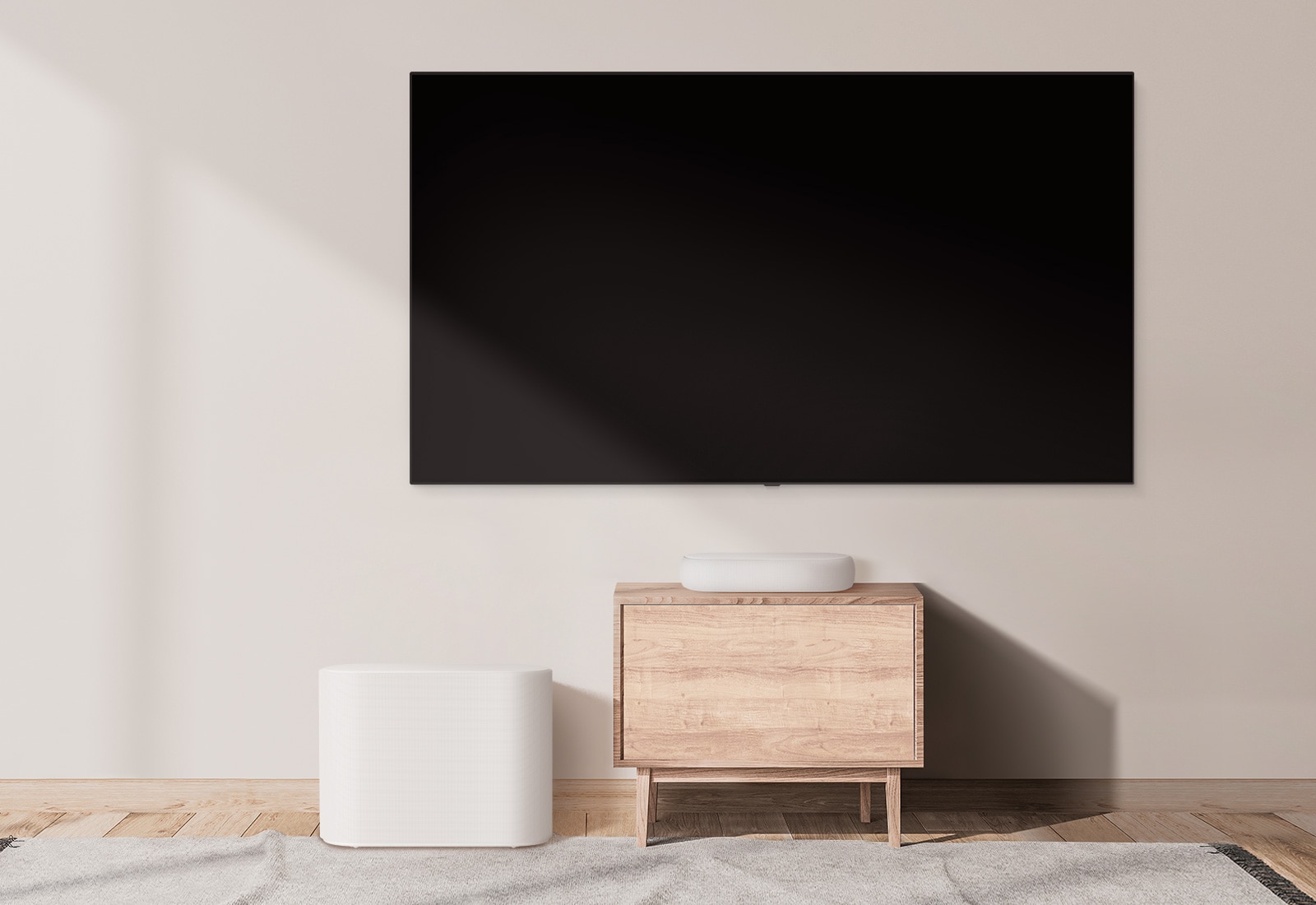 There is a bulky soundbar placed on a wide cabinet and a subwoofer placed on the left. The scene changes and a compact soundbar appears on a smaller cabinet and a subwoofer placed on the left. 