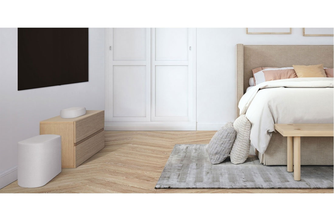 LG QP5W | 3.1.2ch | 320W | Dolby Atmos, A side view of a soundbar and subwoofer placed on a wooden cabinet in a cozy bedroom, QP5W, thumbnail 4