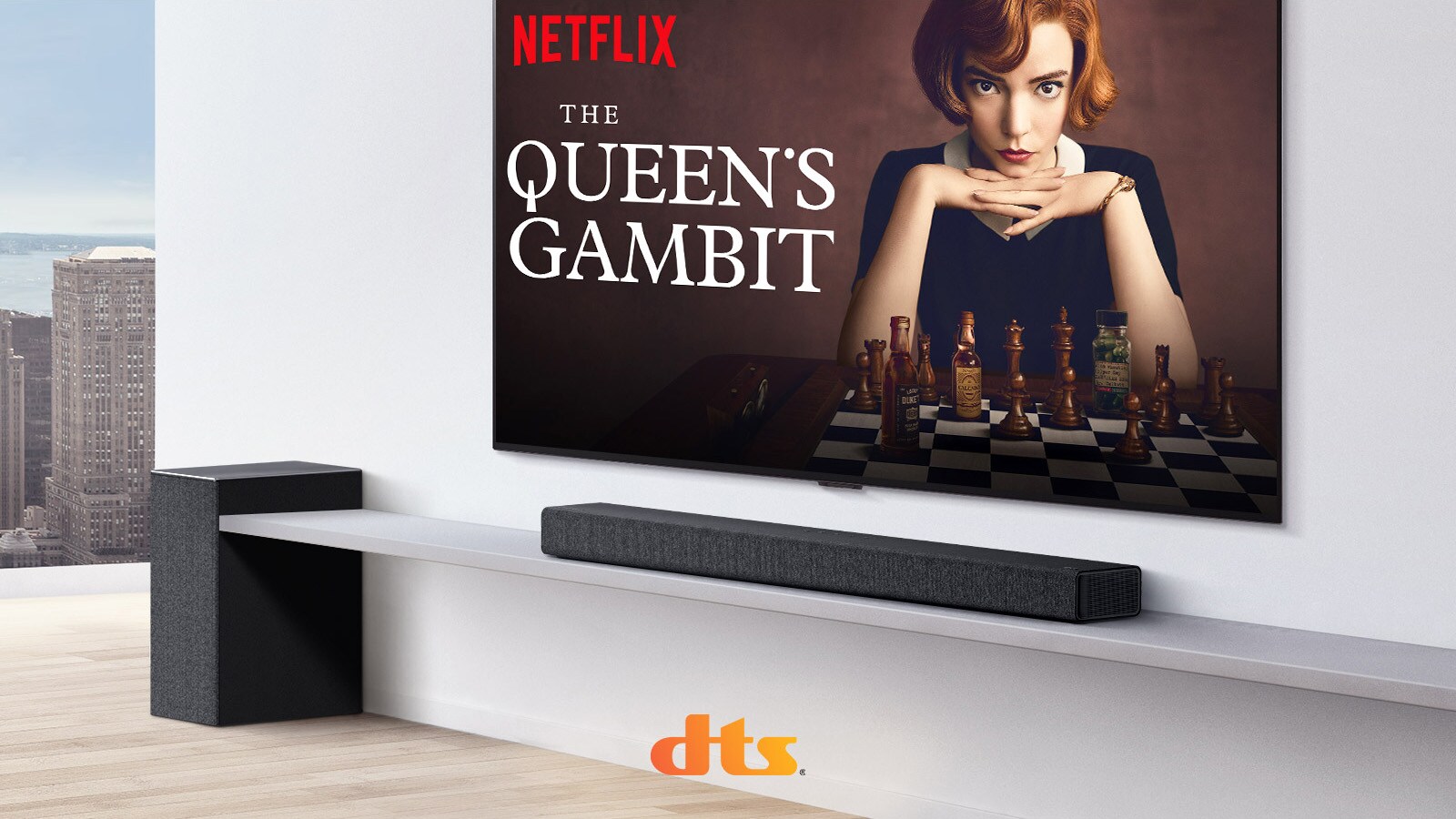 TV is on the wall.  A poster of a TV show is on TV screen. LG Soundbar is right below TV on a white shelf with a sub-woofer right next. Dolby Atmos and DTS:X logo shown on middle bottom of image.