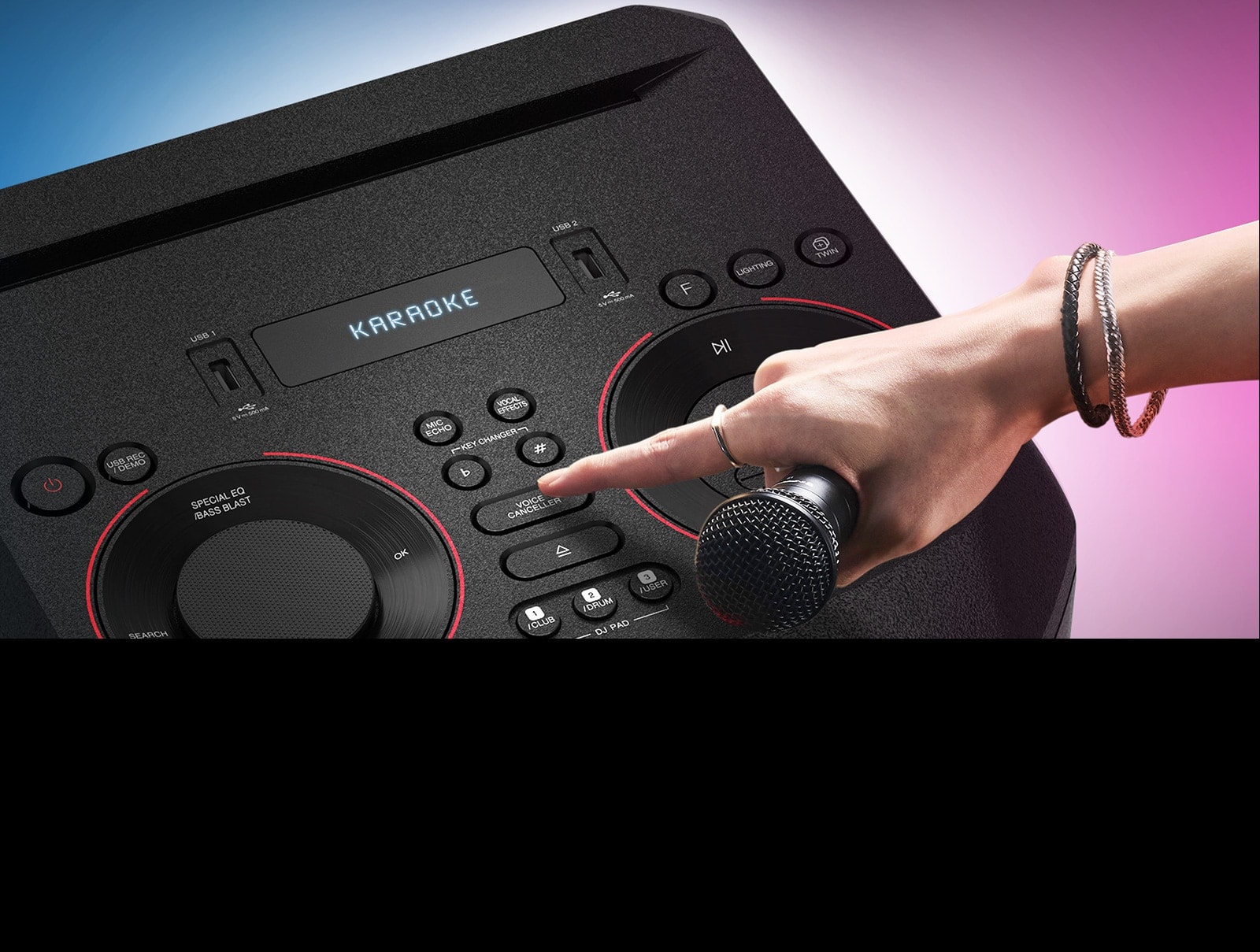 A hand holding a microphone tries to press the Voice canceller button on the top of LG XBOOM.