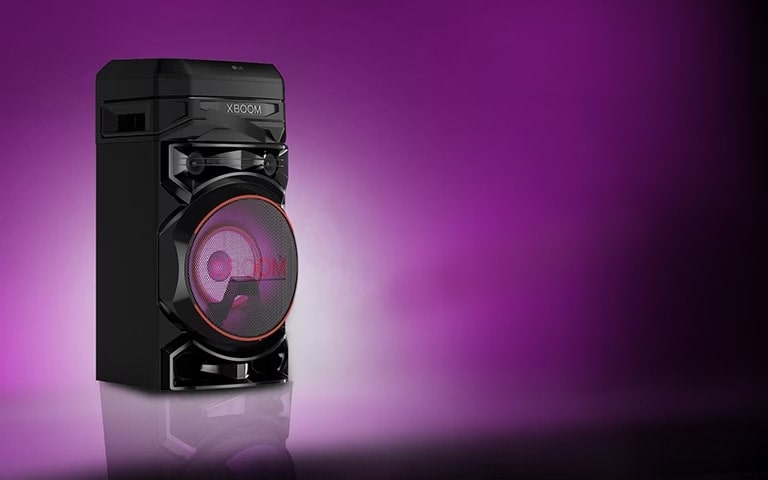 A low angle view of the left side of LG XBOOM against a purple background. The XBOOM light are also purple.