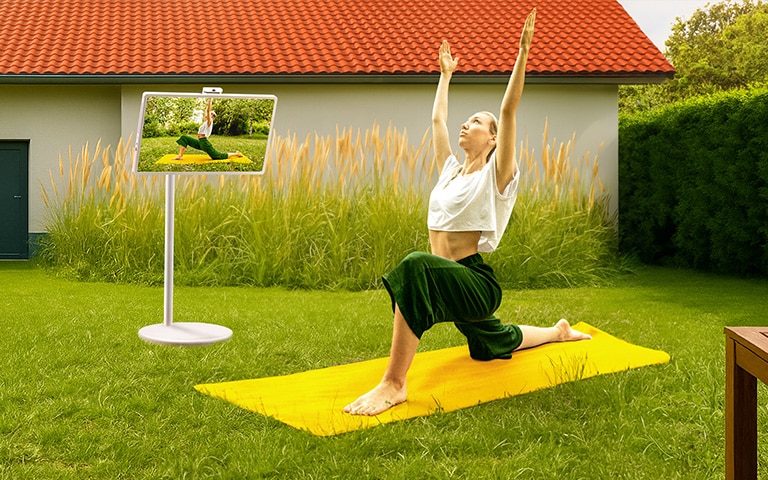 A woman in a yoga pose reflected on the screen of StanbyME 2.